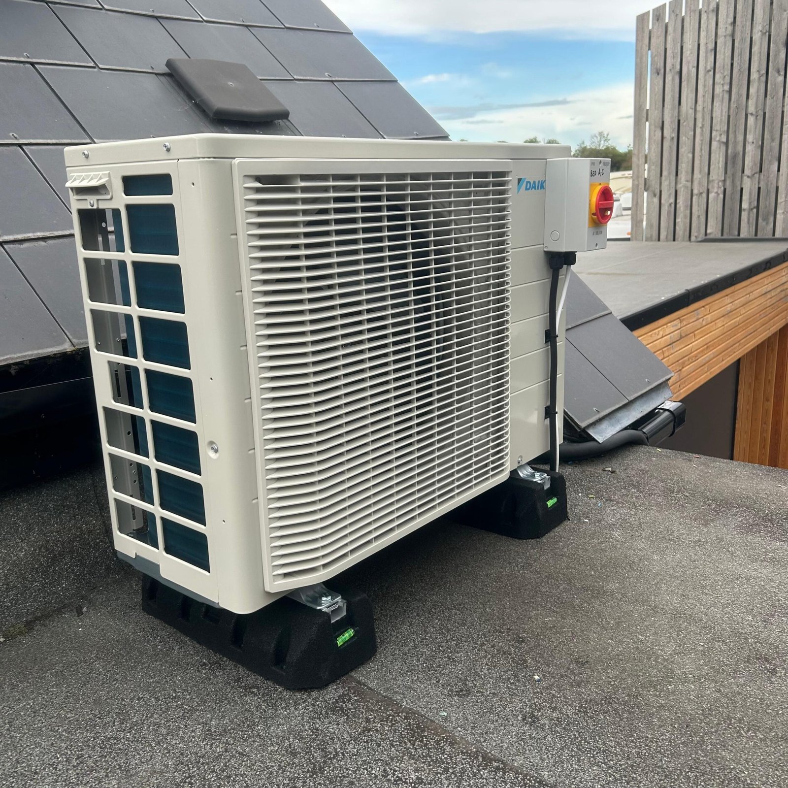 Commercial air conditioning condenser unit installed on a rooftop in Surrey