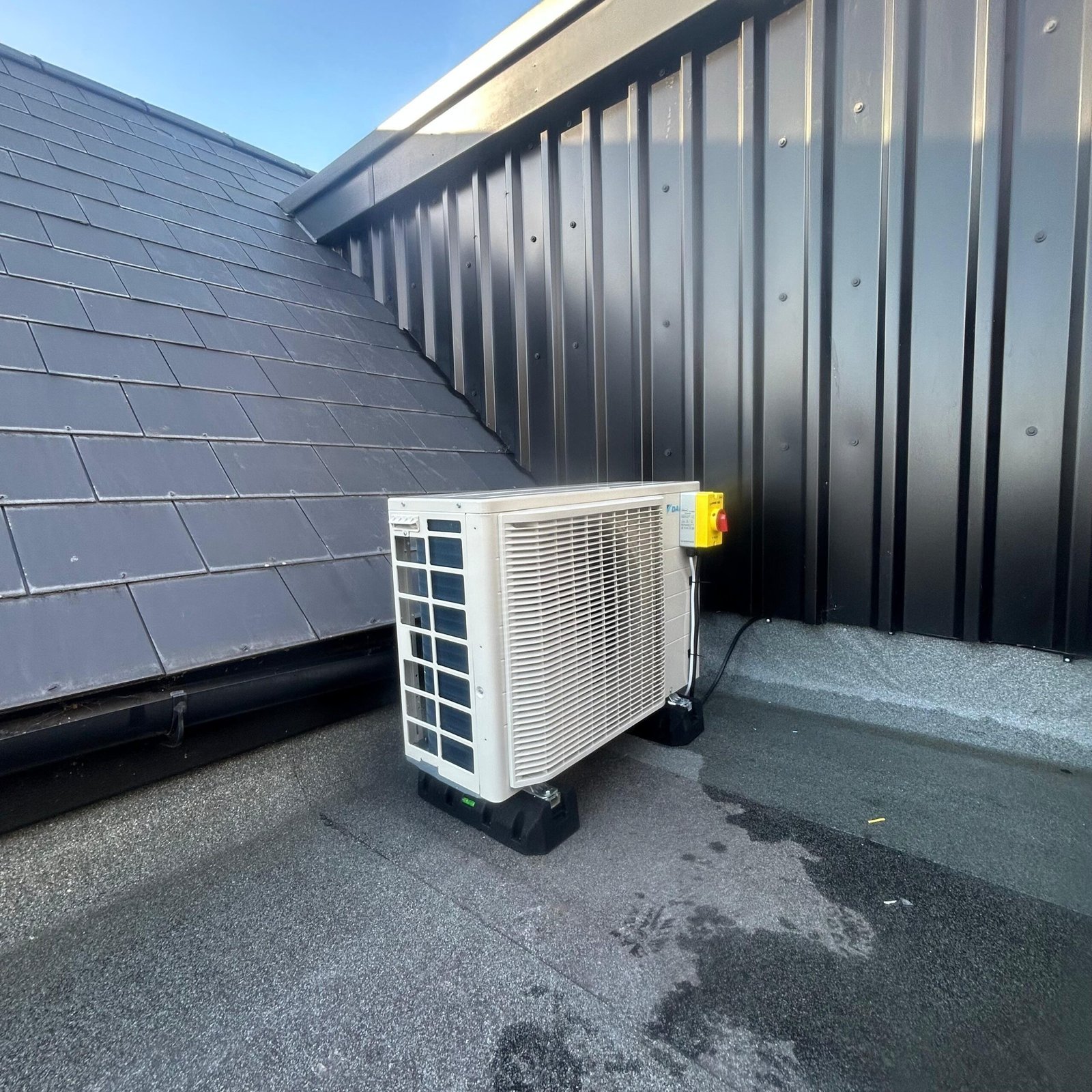 Outdoor air conditioning condenser unit installed by Tempest Air Conditioning on a commercial building in Guildford
