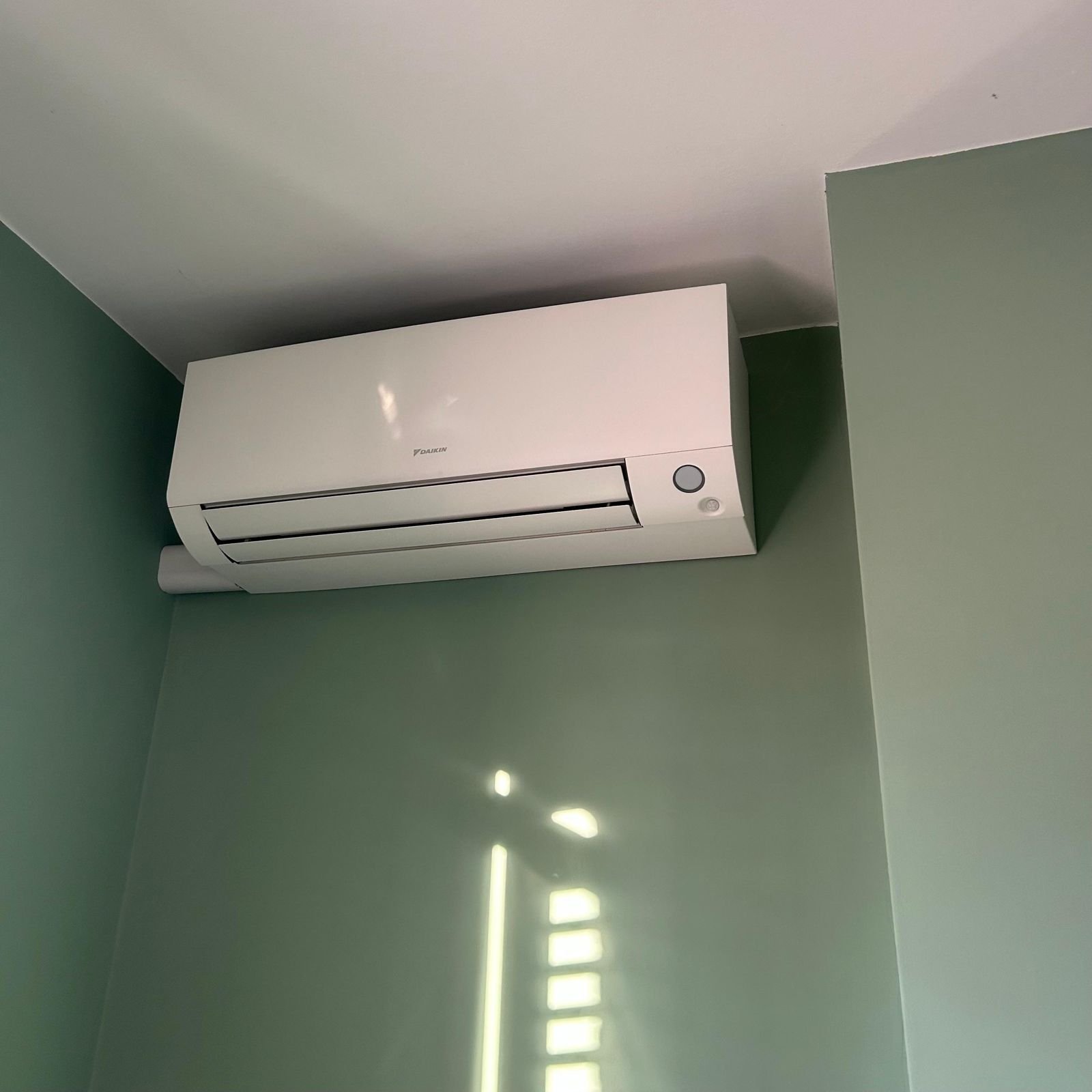 Wall-mounted air conditioning unit fitted in a domestic room in Guildford